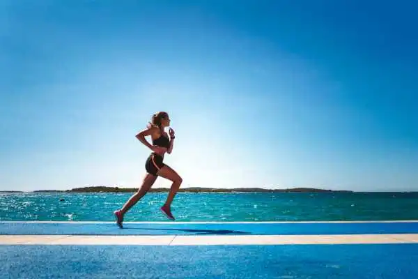 Woman running showing strong leg muscle Marlow